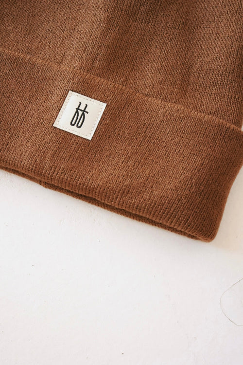 Adult ff Knit Beanie in angle view, showcasing soft fabric and stylish design for warmth and comfort.