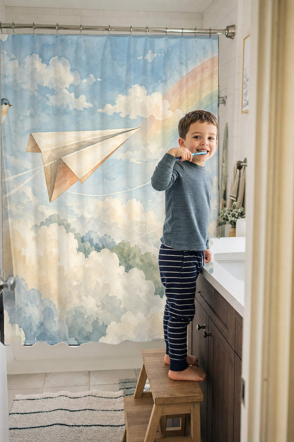 Child brushing teeth in a family bathroom with the Paper Planes shower curtain