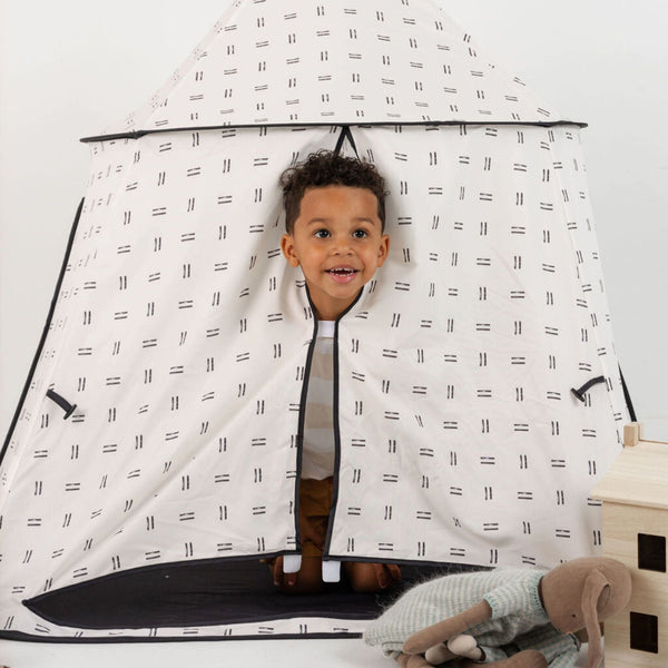 Mudcloth play tent for babies, featuring a stylish design and cozy space for imaginative play. Angle view.