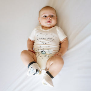 "Massage Me! Onesie for babies 0-6 months, cozy and cute, shown at angle 8."