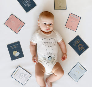 Baby massage cards displayed at an angle, promoting relaxation and bonding for infants and parents.