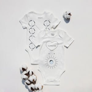 "Massage Me! Onesie for babies 0-6 months, cozy and cute, angled view showcasing soft fabric and playful design."