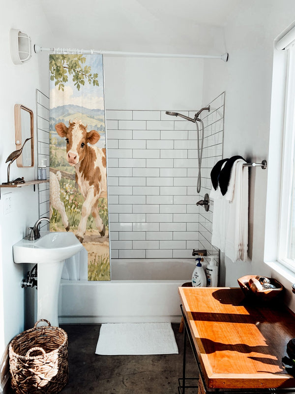 Farm Parade shower curtain hanging on the rod over a white bathtub