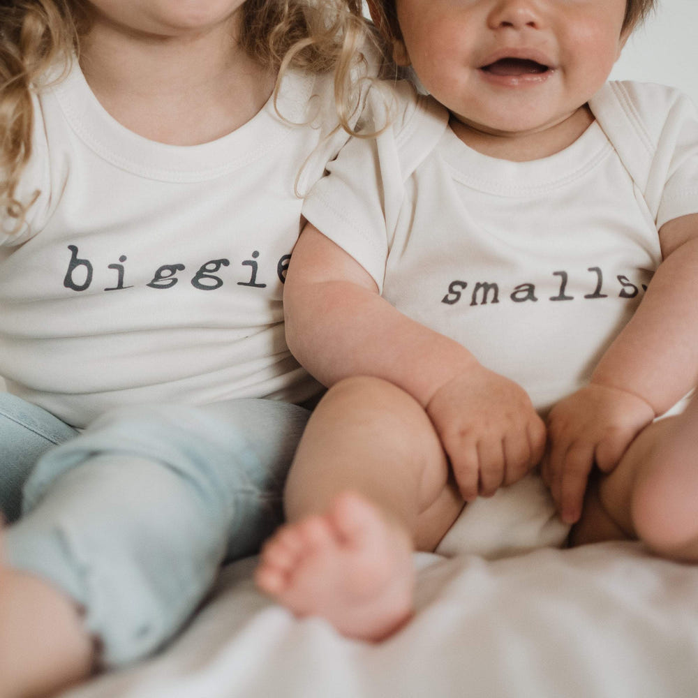 Graphic short sleeve bodysuit for babies in small size, featuring playful designs and soft fabric.
