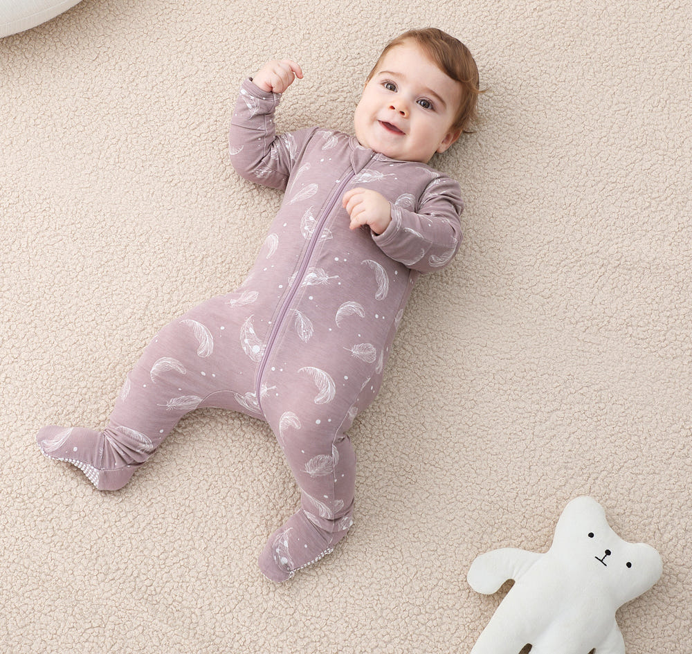 Bamboo long sleeve zip footed pajamas in feather mauve for babies, soft and eco-friendly sleepwear.