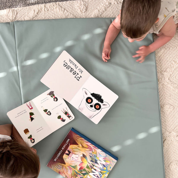 Sage Vegan Leather Play Mat at an angle, perfect for stylish and safe baby playtime.
