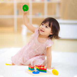 Geometric sorting board for babies, enhancing early learning and sensory play skills. Angle view showcasing vibrant shapes.