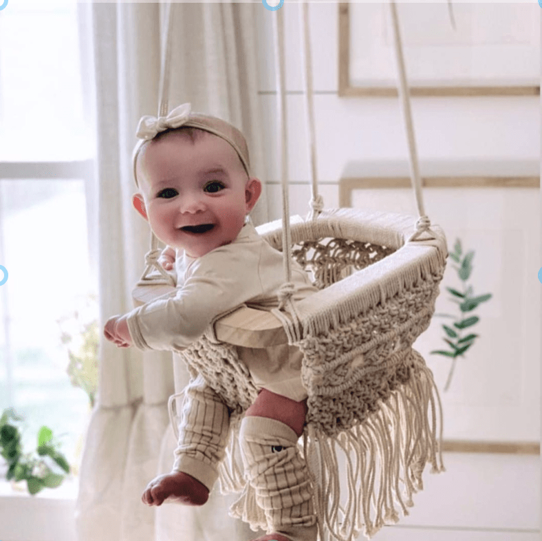 Cozy macrame swing for babies, perfect for indoor play and relaxation. Stylish and safe baby gear.