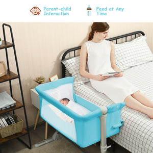 Portable baby bed side sleeper bassinet crib with carrying bag, angled view for travel convenience.