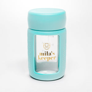 Set of 2 glass breast milk bottles at a 50-degree angle, perfect for safe milk storage.