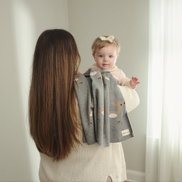 Luxury cotton deer knit swaddle baby blanket in a cozy angle, perfect for keeping your little one warm and stylish.