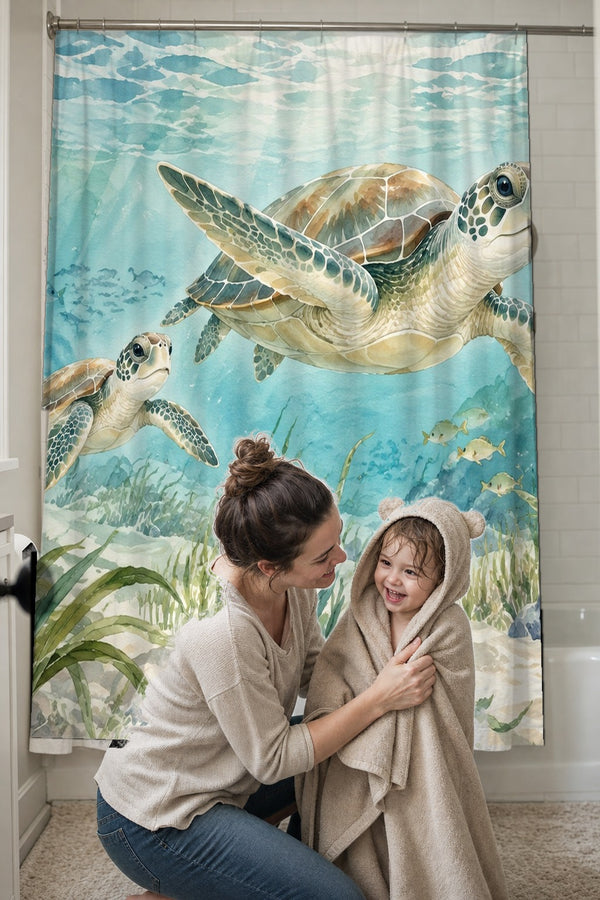 Mom drying her toddler in a hooded towel in front of the Sea Turtles Ocean shower curtain