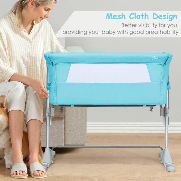 Portable baby bed side sleeper bassinet crib with carrying bag, angled view for travel convenience.