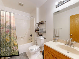 Golden Sunset Wildflowers shower curtain on a tub shower combo in an American family bathroom