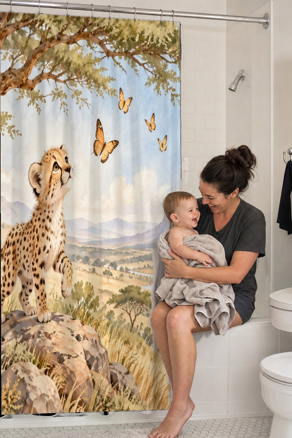 Mom holding her baby on the tub edge next to the Cheetah Cub Safari shower curtain