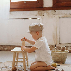 Beige Peak Cap for babies, stylish and comfortable, shown from angle 2. Perfect accessory for little ones.