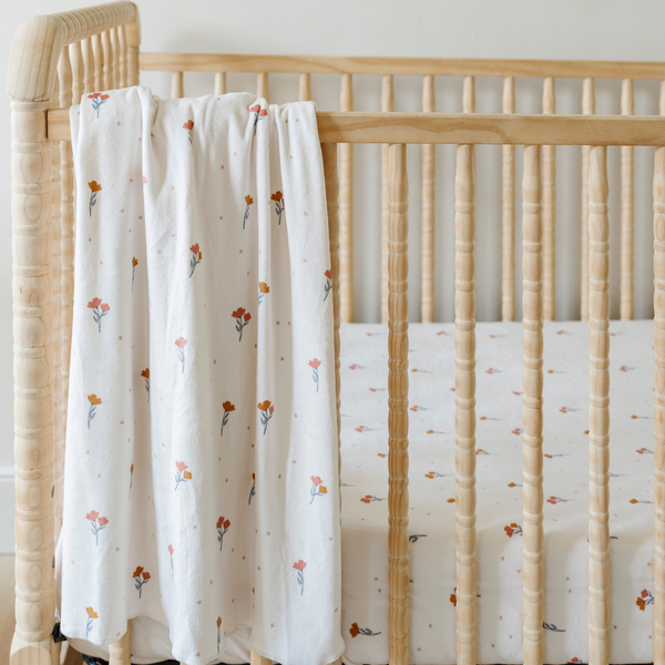 Minky Stretch Luxe Crib Sheets in soft fabric, angled view showcasing stylish design for a cozy nursery.