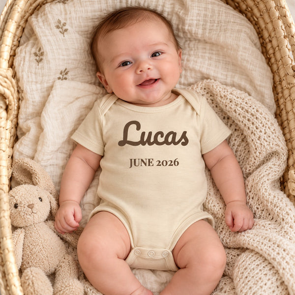 Baby wearing the Name and Birth Month baby bodysuit