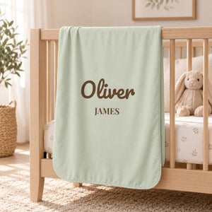 First and Middle Name swaddle blanket in sage, styled photo 1