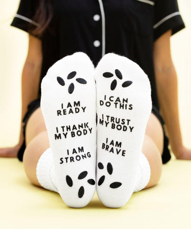 Birthing affirmation hospital socks for comfort and positivity during labor and delivery.