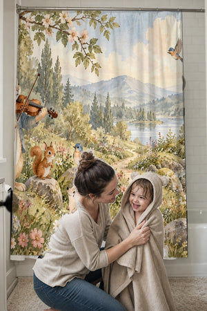 Mom drying her toddler in a hooded towel in front of the Rabbit Violin shower curtain