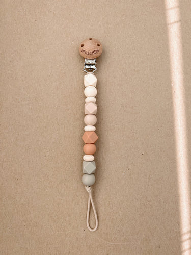 Coral Robin pacifier clip, stylish and functional baby pacifier holder for secure attachment.