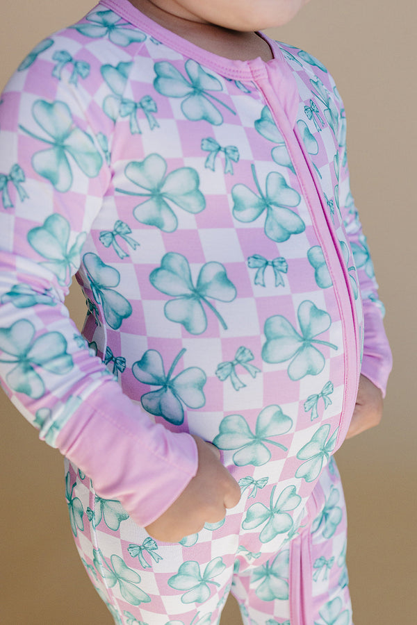 Bamboo Zip Romper in Shamrock & Bows design, showcasing a stylish angle view for baby fashion.