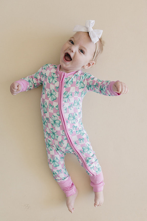 Bamboo Zip Romper in Shamrock & Bows design, angled view showcasing soft, eco-friendly fabric for babies.