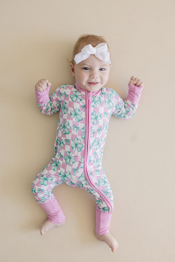 Bamboo Zip Romper in Shamrock & Bows design, angled view showcasing soft fabric and cute style for babies.