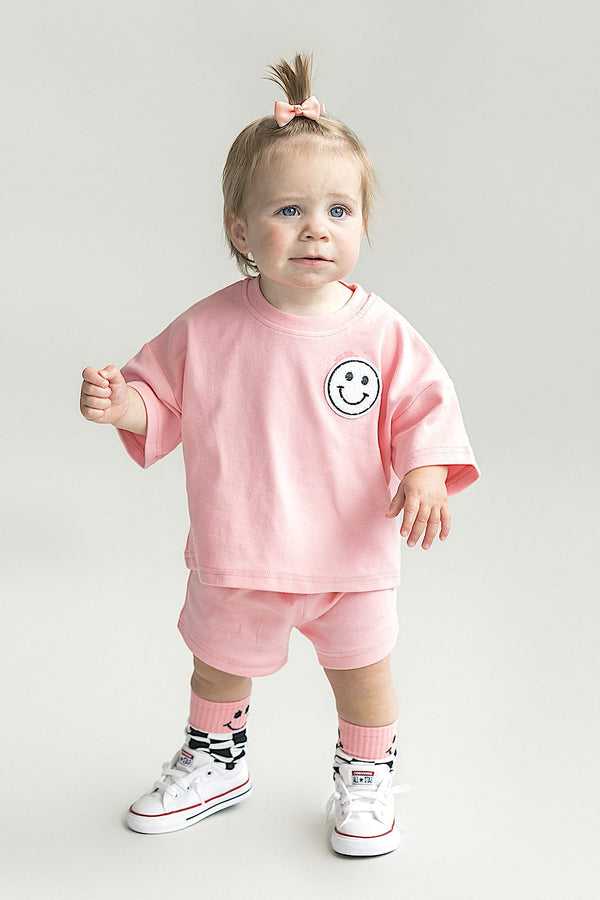Pink peach Smiley Shorts Set for babies, showcasing a playful design from angle 2. Perfect for summer outfits.