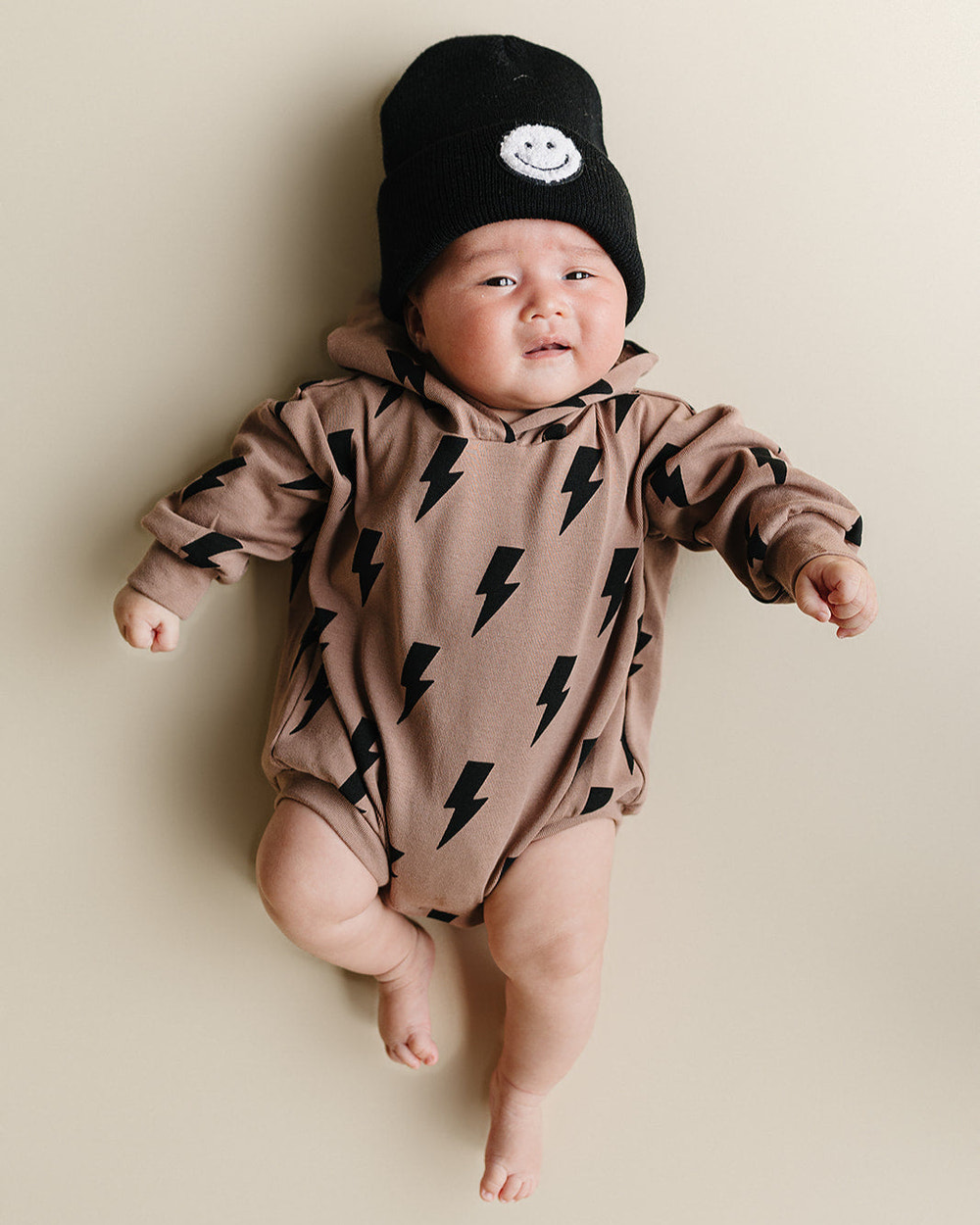 Hooded bubble romper in mocha bolts for babies, perfect for stylish and cozy playtime.