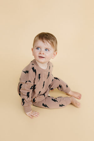 Baby jogger set in mocha bolts, stylish and comfortable lounge wear for infants, shown from angle 3.