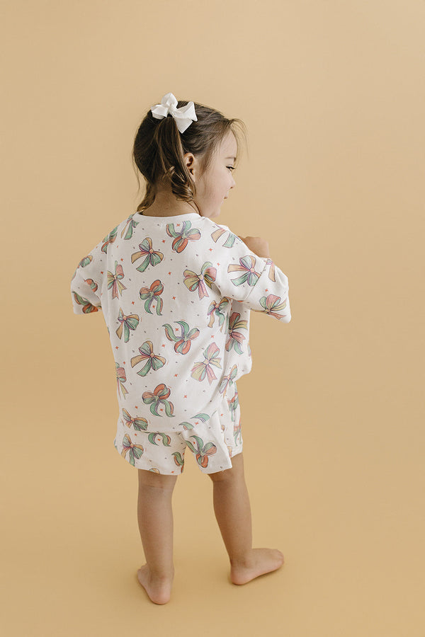 Baby shorts set with happy bows, featuring a playful design and vibrant colors, angled view showcasing style and comfort.