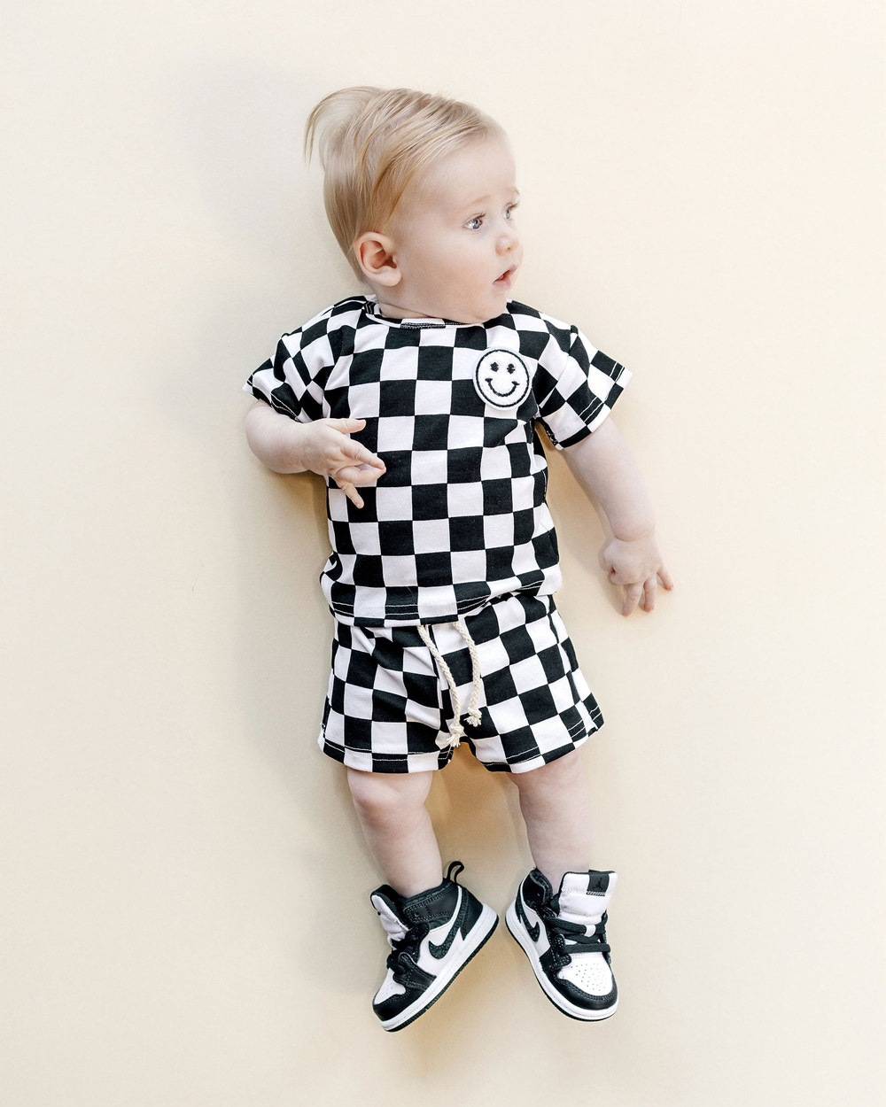 Black checkered shorts set for babies, stylish and comfortable for warm weather.