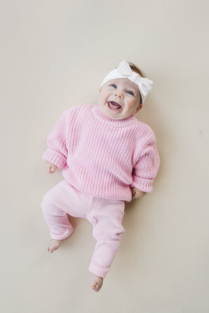 Pink chunky knit sweater for babies, stylish and cozy, shown at angle 10. Perfect for chilly days.