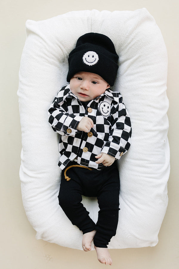 Smiley checkered black cotton shacket for babies - stylish and cozy jacket for little ones.