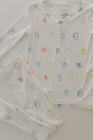 Bamboo two-piece pajamas for kids, featuring autism awareness design by Charli Counts, shown from angle 2.