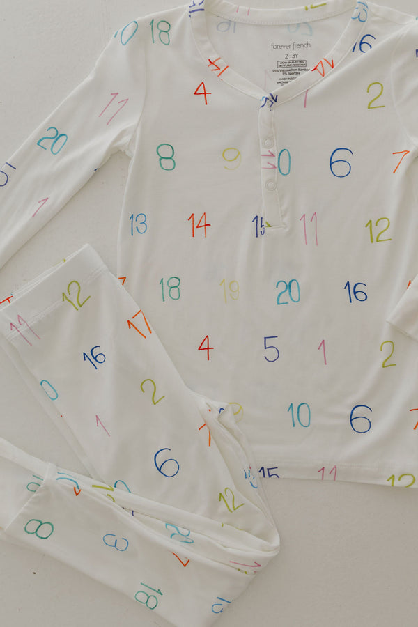 Bamboo two-piece pajamas for kids, featuring autism awareness design by Charli Counts, shown from angle 2.