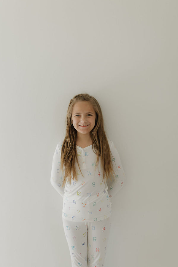 Bamboo two-piece pajamas for kids, featuring autism awareness design by Charli Counts, shown at angle 6.