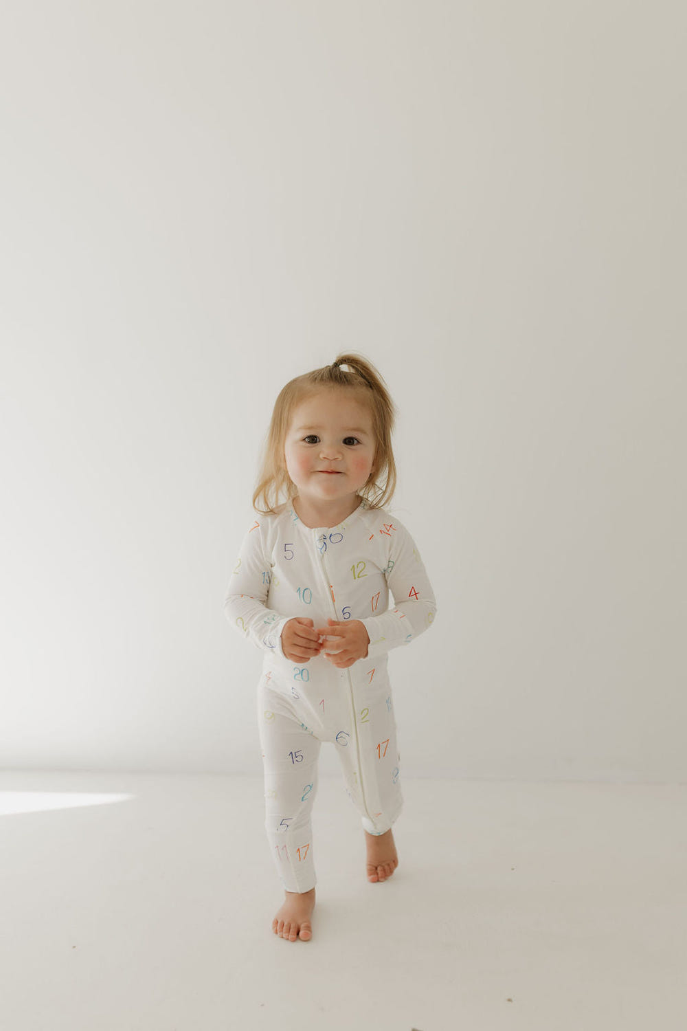Bamboo zip pajamas for babies, featuring Autism Awareness design by Charli Counts. Soft, eco-friendly, and stylish.