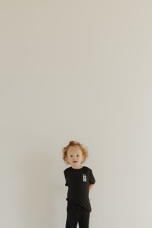 Toddler black bamboo lounge set, short sleeve pajamas, stylish and comfortable for kids. Angle 2 view.
