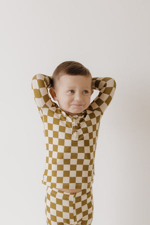 Bamboo two-piece pajamas in olive checkerboard pattern for babies, soft and comfortable sleepwear.