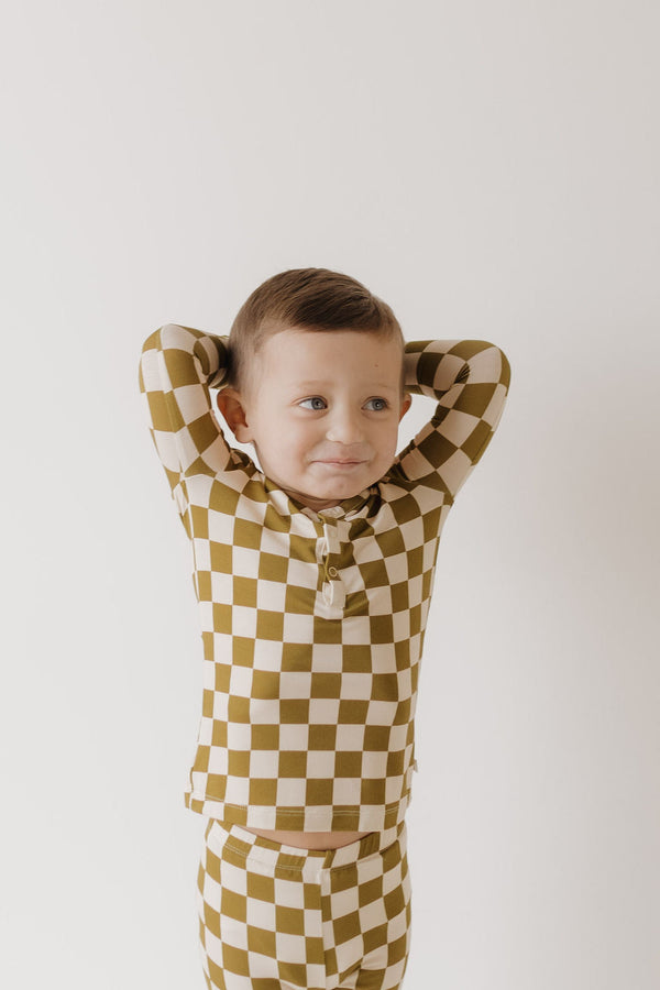 Bamboo two-piece pajamas in olive checkerboard pattern for babies, soft and comfortable sleepwear.