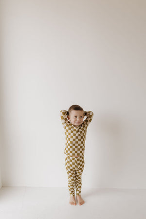 Bamboo two-piece pajamas in olive checkerboard pattern, angle view showcasing soft, breathable fabric for babies.