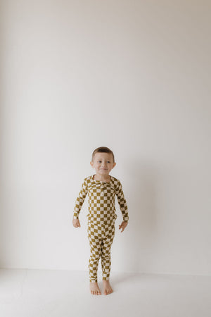 Bamboo two-piece pajamas in olive checkerboard pattern, angle view showcasing soft, breathable fabric for babies.