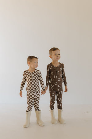 Bamboo two-piece pajamas for babies by Giddy Up, angle view showcasing soft, breathable fabric and playful design.