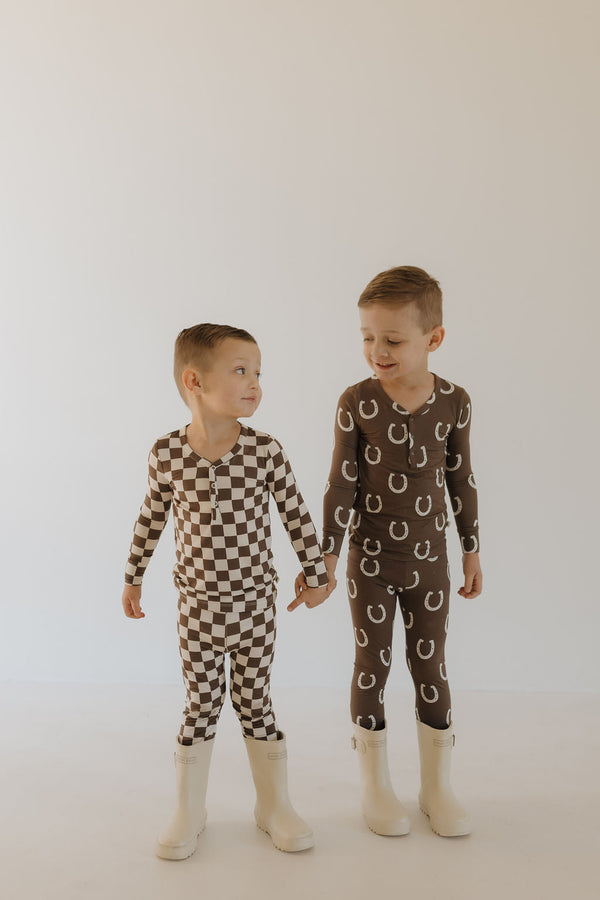 Bamboo two-piece pajamas for babies in playful Giddy Up design, angle view showcasing soft fabric and vibrant colors.