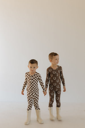 Bamboo two-piece pajamas for babies by Giddy Up, shown at a 15-degree angle. Soft, breathable, and stylish sleepwear.