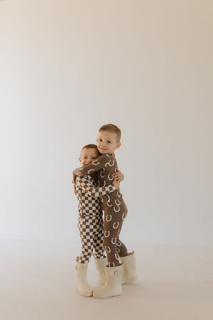 Bamboo two-piece pajamas for babies by Giddy Up, featuring a cozy and stylish design in a playful angle view.