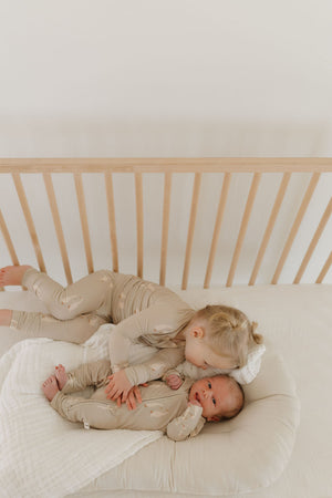 Bamboo Zip Pajamas by Silly Goose in angle view, soft and cozy for babies. Perfect for comfortable sleep.